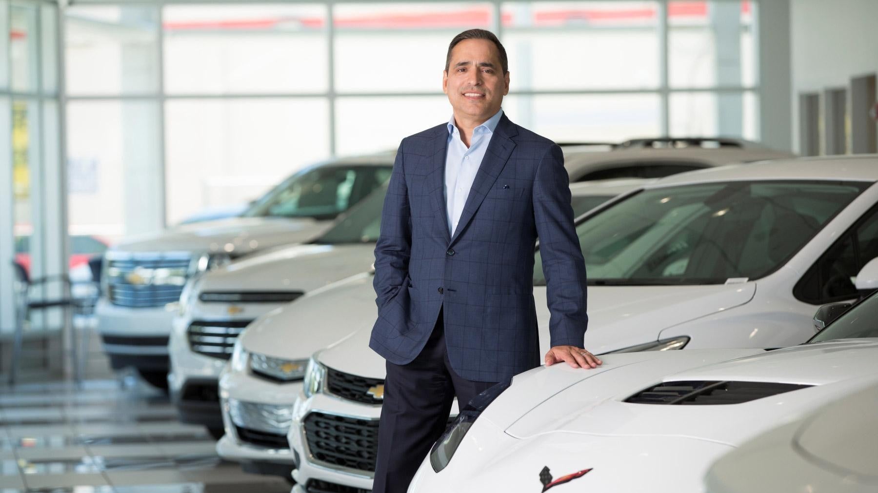 Owner standing by car Bomnin Buick GMC Nanuet in Nanuet NY